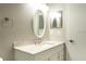 Bathroom featuring a white vanity, modern fixtures, and an oval mirror with lighting at 5560 Metrowest Nw Blvd # 106, Orlando, FL 32811