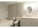Bathroom featuring a tub with shower, tiled walls, and vanity with white cabinets at 5560 Metrowest Nw Blvd # 106, Orlando, FL 32811