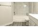 Bathroom featuring a tub with shower, tiled walls, and vanity at 5560 Metrowest Nw Blvd # 106, Orlando, FL 32811