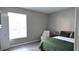 Bedroom featuring a green quilted bed set and a nearby window with natural light at 5560 Metrowest Nw Blvd # 106, Orlando, FL 32811