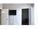 Bedroom featuring a wall mounted TV and walk-in closet with luggage inside at 5560 Metrowest Nw Blvd # 106, Orlando, FL 32811