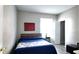 Bedroom with light gray walls, wood floors, a bed, and a side table by the window at 5560 Metrowest Nw Blvd # 106, Orlando, FL 32811