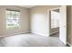 Bedroom featuring neutral paint, wood-look flooring, and a window overlooking the street at 5560 Metrowest Nw Blvd # 106, Orlando, FL 32811