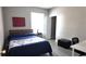Well-lit bedroom with a bed, a side table, and view to an adjacent closet at 5560 Metrowest Nw Blvd # 106, Orlando, FL 32811