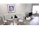 Cozy dining area with modern lighting, glass table and gray wood-look flooring at 5560 Metrowest Nw Blvd # 106, Orlando, FL 32811