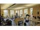 Well-equipped gym featuring weight machines, free weights, and large windows for natural light at 5560 Metrowest Nw Blvd # 106, Orlando, FL 32811