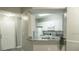 A bright kitchen featuring white cabinets, granite countertops, and a stainless sink at 5560 Metrowest Nw Blvd # 106, Orlando, FL 32811