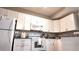 Bright white kitchen with modern appliances and light granite counter tops at 5560 Metrowest Nw Blvd # 106, Orlando, FL 32811