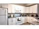 Bright kitchen with stainless steel appliances, granite counters and white cabinets at 5560 Metrowest Nw Blvd # 106, Orlando, FL 32811