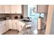 Modern kitchen featuring granite countertops, white cabinets, and stainless steel sink at 5560 Metrowest Nw Blvd # 106, Orlando, FL 32811