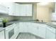 A kitchen view with white cabinets, stainless appliances, and granite counter tops at 5560 Metrowest Nw Blvd # 106, Orlando, FL 32811