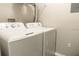 Practical laundry room with a white washer and dryer set for convenient in-home laundry at 5560 Metrowest Nw Blvd # 106, Orlando, FL 32811