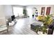Inviting living room with gray wood-look floors, and a doorway to a cozy outdoor seating area at 5560 Metrowest Nw Blvd # 106, Orlando, FL 32811