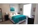Comfortable main bedroom featuring a bright window, teal accents and luxury vinyl plank flooring at 5560 Metrowest Nw Blvd # 106, Orlando, FL 32811