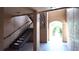 Open air stairwell leading to an arched entryway with a view of trees at 5560 Metrowest Nw Blvd # 106, Orlando, FL 32811