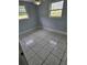Simple bedroom with neutral walls and tile flooring with window allowing natural light at 58 Lincoln St, Frostproof, FL 33843