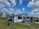 Charming single-story home with carport and uniquely painted exterior at 58 Lincoln St, Frostproof, FL 33843