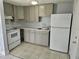 Functional kitchen featuring grey cabinets, laminate countertops, and a white refrigerator at 58 Lincoln St, Frostproof, FL 33843