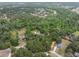 Aerial view of houses in a heavily wooded area, with pond, lake, and apartments visible at 6340 Nelms E Rd, Lakeland, FL 33811