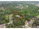 Aerial view of the property with boundary lines, pool, lush trees, and surrounding neighborhood at 6340 Nelms E Rd, Lakeland, FL 33811