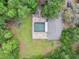 Aerial view of a secluded home featuring a screened pool and lush, mature landscaping at 6340 Nelms E Rd, Lakeland, FL 33811