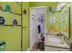 Charming bathroom with whimsical bird and flower-themed wall art, granite countertop, and access to a toilet room at 6340 Nelms E Rd, Lakeland, FL 33811