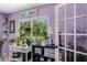 Bright and cozy craft room with large window overlooking the lush backyard and a door to another room at 6340 Nelms E Rd, Lakeland, FL 33811