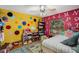 Bright and cheerful ' room with colorful walls, fun polka dots, alphabet wall, and a playful dollhouse area at 6340 Nelms E Rd, Lakeland, FL 33811