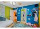 Whimsical bedroom with colorful walls, number decals, and ample space for toys, play and imagination at 6340 Nelms E Rd, Lakeland, FL 33811