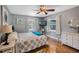 Comfortable bedroom with a stylish ceiling fan, modern TV, dresser, and inviting windows for natural light at 6340 Nelms E Rd, Lakeland, FL 33811