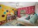 Fun, colorful bedroom featuring playful polka dots, alphabet wall, and a charming play area with toys and bookshelves at 6340 Nelms E Rd, Lakeland, FL 33811