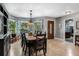 Elegant dining room featuring a large table, stylish decor, and bay windows offering natural light and scenic views at 6340 Nelms E Rd, Lakeland, FL 33811