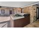Inviting hot tub area with a brick wall, and covered patio for outdoor relaxation and entertainment at 6340 Nelms E Rd, Lakeland, FL 33811