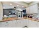 Kitchen with granite countertops, white cabinetry, and view into the living room with backyard views at 6340 Nelms E Rd, Lakeland, FL 33811