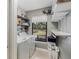 Functional laundry room with ample shelving, modern washer, and a serene view of the backyard at 6340 Nelms E Rd, Lakeland, FL 33811