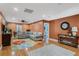 Spacious living room with hardwood floors, a ceiling fan, comfortable seating, and a view of the backyard at 6340 Nelms E Rd, Lakeland, FL 33811