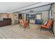 Inviting outdoor patio with ceiling fan, TV, seating, and wood flooring offers relaxation and entertainment at 6340 Nelms E Rd, Lakeland, FL 33811