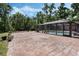 Expansive brick patio area surrounded by lush greenery, perfect for outdoor entertaining at 6340 Nelms E Rd, Lakeland, FL 33811