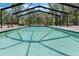 Sparkling in-ground pool enclosed by a screen, providing a refreshing and private outdoor oasis at 6340 Nelms E Rd, Lakeland, FL 33811