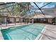 Stunning in-ground pool with screen enclosure, offering privacy and a seamless indoor-outdoor living experience at 6340 Nelms E Rd, Lakeland, FL 33811