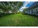 Large backyard with green grass, hedge and tree landscaping, perfect for outdoor activities at 8374 Bowden Way, Windermere, FL 34786