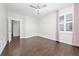 Bright bedroom featuring wood-look tile flooring, ceiling fan, and large window with shutters at 8374 Bowden Way, Windermere, FL 34786