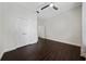 Bright bedroom featuring dark hardwood floors, a ceiling fan and a closet at 8374 Bowden Way, Windermere, FL 34786