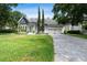 Beautiful home with manicured lawn, mature trees, and a three-car garage at 8374 Bowden Way, Windermere, FL 34786