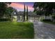 Charming home with a well-manicured lawn, mature trees, and a brick driveway at 8374 Bowden Way, Windermere, FL 34786