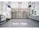 Spacious garage with epoxy flooring, storage cabinets, and a work out area at 8374 Bowden Way, Windermere, FL 34786