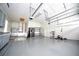 Spacious garage with epoxy flooring, overhead storage racks, and ample space for a home gym at 8374 Bowden Way, Windermere, FL 34786