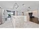 Modern, open-concept kitchen with dual islands, stainless appliances, and sliding glass doors to the outdoor living space at 8374 Bowden Way, Windermere, FL 34786