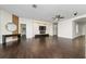 Open living room with hardwood floors, modern fixtures, and a unique decorative wall at 8374 Bowden Way, Windermere, FL 34786