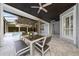 Covered patio with outdoor dining table and view of the pool and dark paneled roof at 8374 Bowden Way, Windermere, FL 34786